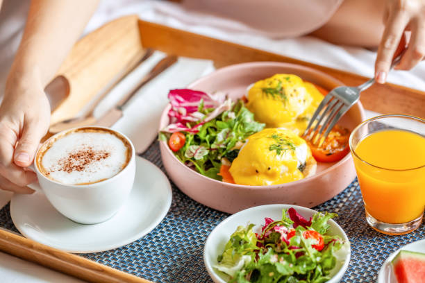 istock Breakfast in Bed with Coffee, Orange Juice, Salad, Fruits and Eggs Benedict 1349589905