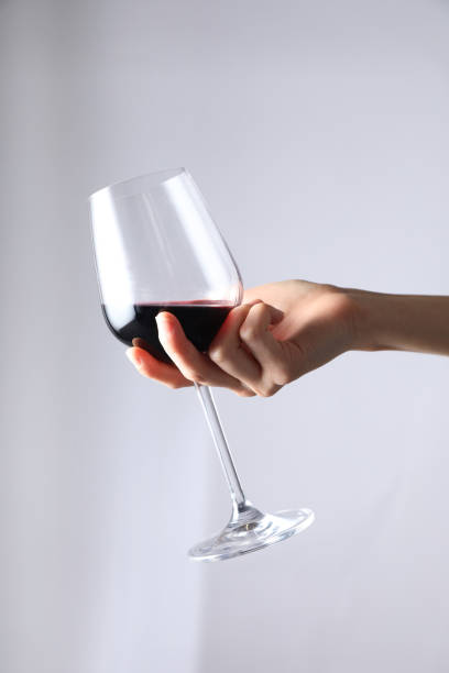 istock A woman holding a wine glass with red wine. 1349590037