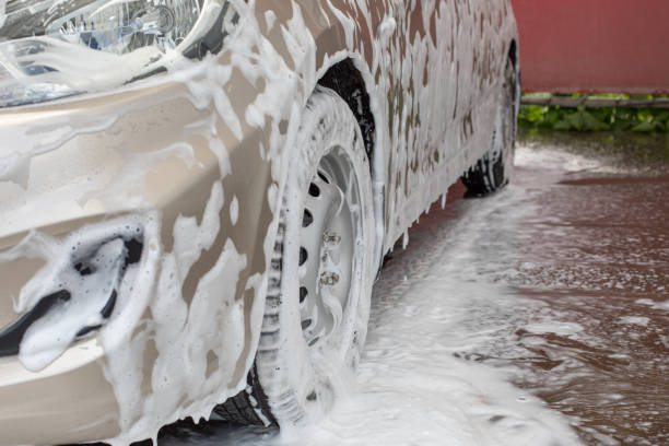 istock Car wash service, car wheel in shampoo foam 1349592562