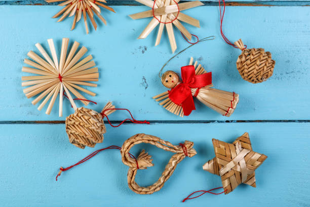 istock Straw Christmas tree decorations on a blue wooden background 1349596882