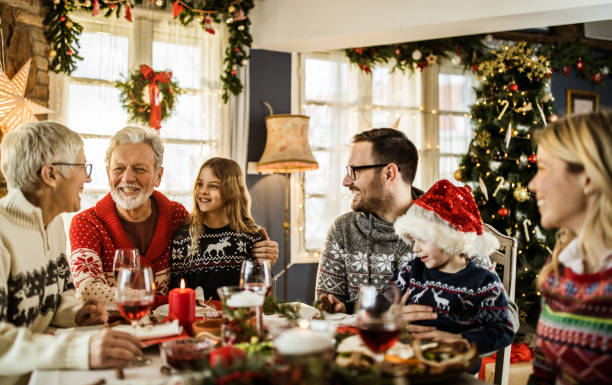 istock Happy extended family talking during New Year's meal at dining table. 1349603438