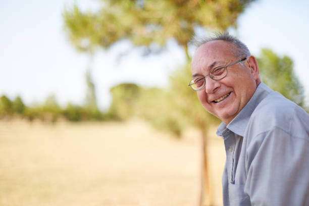 old man with hearing aid outdoors
