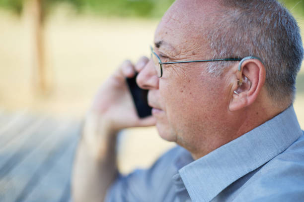 istock Old man on the phone with hearing aid 1349606775
