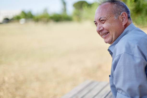 old man with hearing aid outdoors
