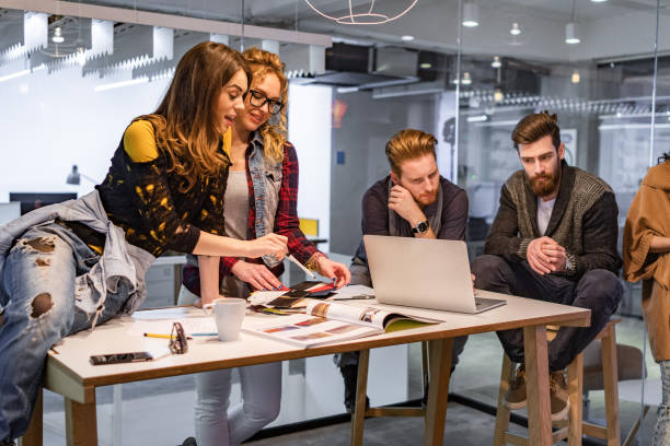 istock Young multi-tasking freelancers working at casual office. 1349607164