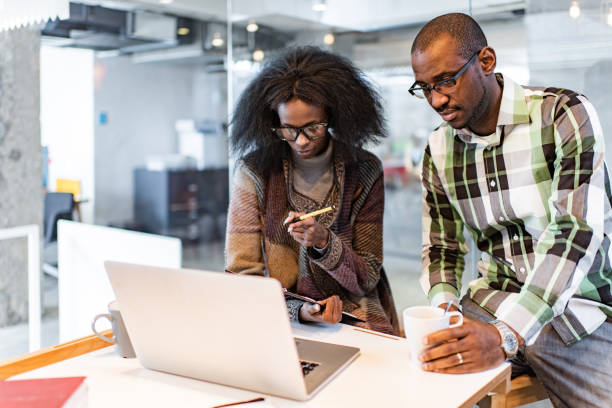 istock African American colleagues working on reports and computer in the office. 1349607274