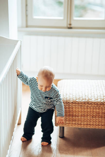 istock little kid start to walking at home 1349608193