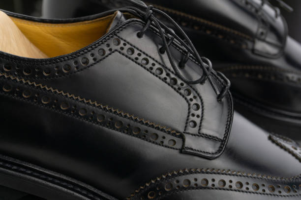 istock Black brogue derby shoes on cedar shoe-tree close up 1349608213