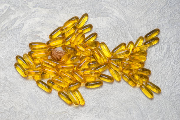 Omega3 capsules in fish shape. EPA and DHA are essential fatty substances that our bodies need on a daily basis. Omega3 capsules in fish shape. EPA and DHA are essential fatty substances that our bodies need on a daily basis. eicosapentaenoic acid stock pictures, royalty-free photos & images