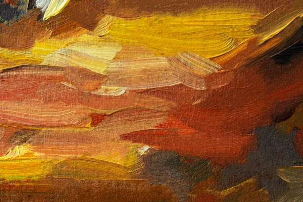 Abstract background autumn painting. Orange brown yellow beige mixed colors of oil paint. A fragment of an artwork in different shades of autumn shades. Modern handmade design with a brush on canvas