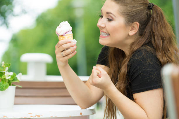 istock Young woman eating ice cream 1349632761