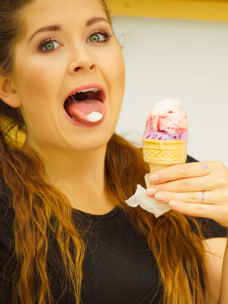 istock Young woman eating ice cream 1349633212