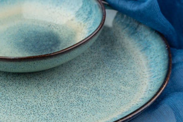 istock Ceramic plate on a wooden table top view. minimalist handmade ceramic tableware and pottery 1349633813