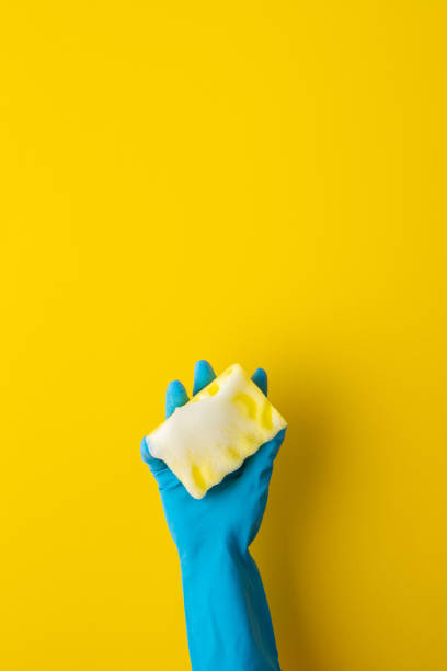 istock Hand in rubber gloves hold a dishwashing sponge 1349637597