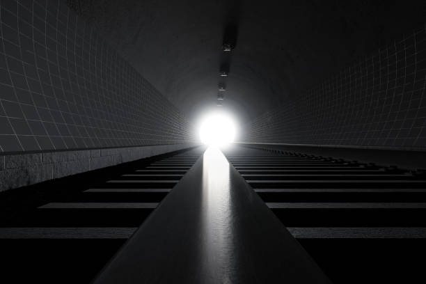 istock 3d rendering of darken train tunnel with light at the end 1349643413