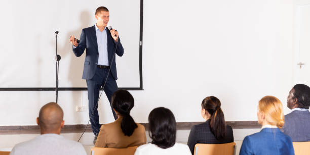 istock Male coach giving speech at conference hall 1349645248
