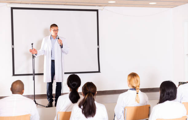 istock Male coach giving speech at conference hall 1349645254