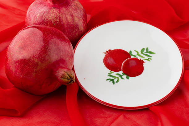 istock pomegranate fruit with turkish jewellery and open pomegranate on an red, side view 1349645786
