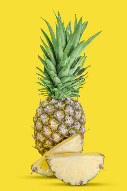 istock Ripe whole pineapple with slices 1349649030