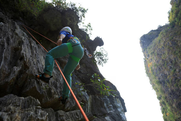 istock Female rock climber on cliff 1349658190