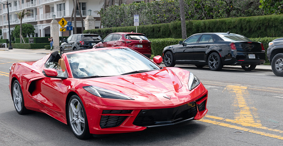 Palm Beach, Florida USA - March 21, 2021: red Chevrolet (Chevy) Corvette Stingray luxury car on road in palm beach, united states of america. front view.