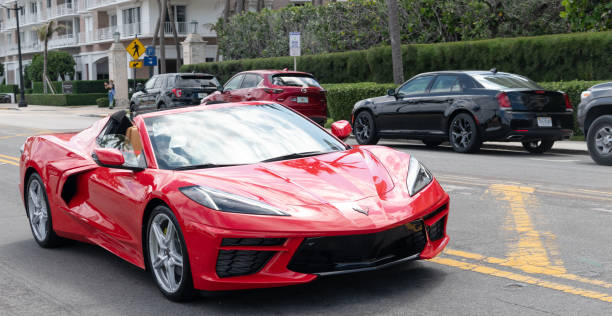 red Chevrolet (Chevy) Corvette Stingray luxury car Palm Beach, Florida USA - March 21, 2021: red Chevrolet (Chevy) Corvette Stingray luxury car on road in palm beach, united states of america. front view. Chevrolet stock pictures, royalty-free photos & images