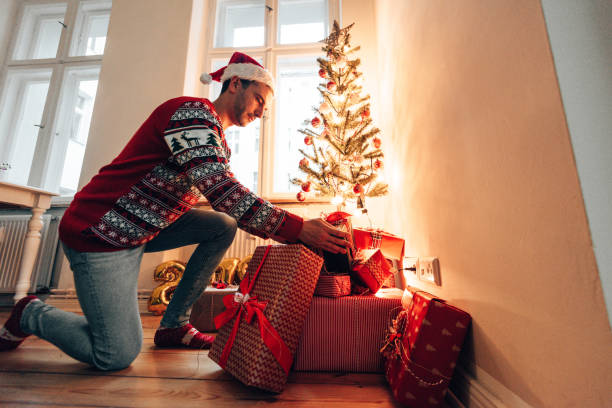 istock moving the christmas gifts under the christmas tree 1349659609