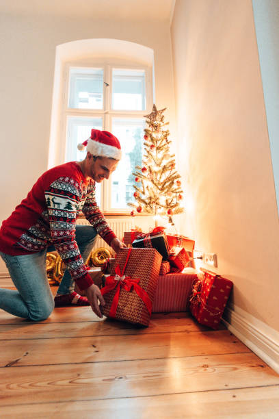 istock moving the christmas gifts under the christmas tree 1349659675