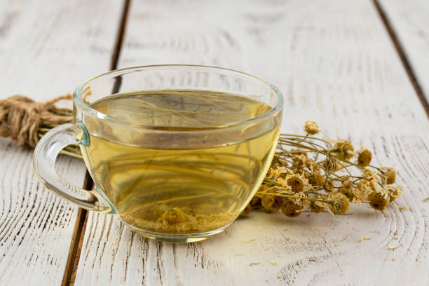 istock Cup of delicious camomile tea on table 1349661488