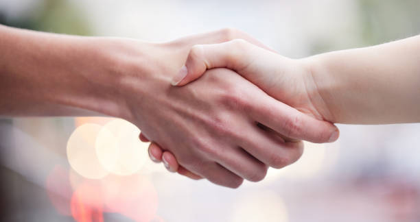 istock Shot of two unrecognizable businesspeople shaking hands 1349663726
