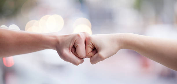 istock Shot of two unrecognizable people fist bumping 1349663728