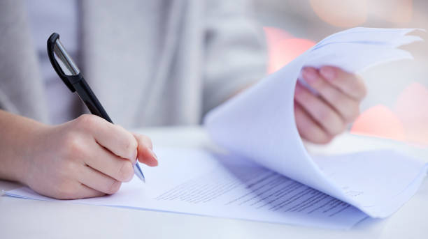istock Shot of an unrecognizable businessperson going through paperwork at work 1349663729