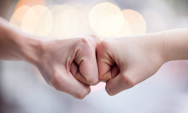 istock Shot of two unrecognizable people fist bumping 1349663730