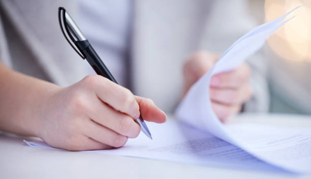 istock Shot of an unrecognizable businessperson going through paperwork at work 1349663732