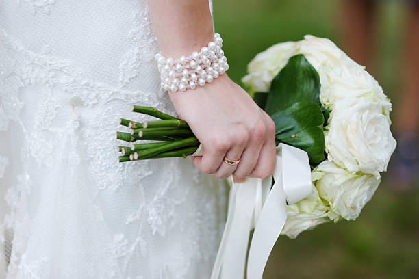 istock Bride holding white wedding flowers bouquet 134966503
