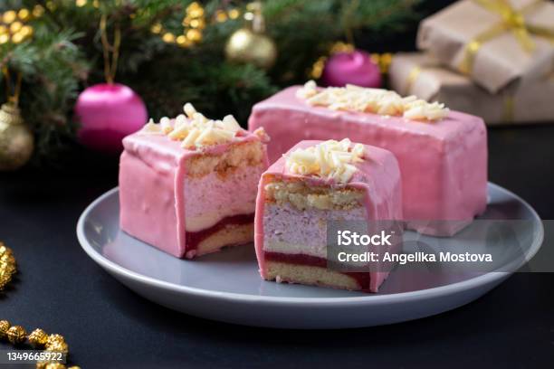 Sliced Mousse Desserts With Almond Biscuit Strawberry Coolie And Strawberry Mousse Covered Gourmet Pink Chocolate Glaze On New Year Background Closeup Stock Photo - Download Image Now