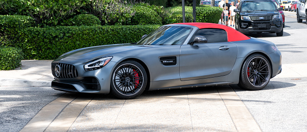 Palm Beach, Florida USA - March 21, 2021: grey Mercedes-benz AMG GTS V8 Bi-turbo luxury sport supercar with red convertible roof parked in palm beach, usa. side view.