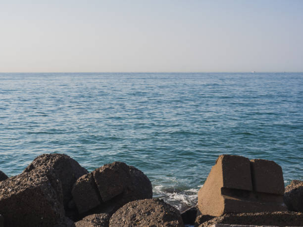 Breakwater next to the Mediterranean Sea and clear blue sky