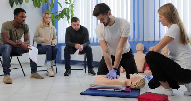 Instructor demonstrating CPR on mannequin at first aid training course. Instructor demonstrating CPR on mannequin at first aid training course cpr stock pictures, royalty-free photos & images