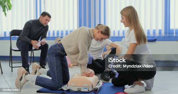 Woman Demonstrating Cpr On Mannequin In First Aid Class Stock Photo - Download Image Now