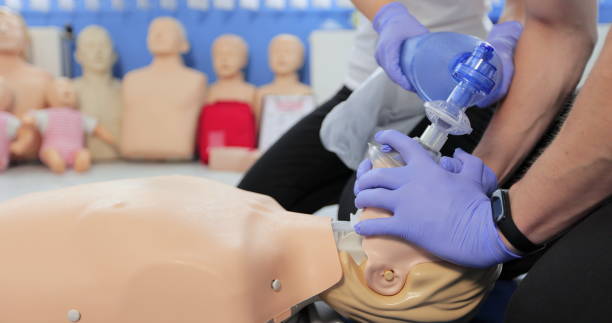 istock CPR training using and an AED and bag mask valve on an adult training manikin. 1349671102