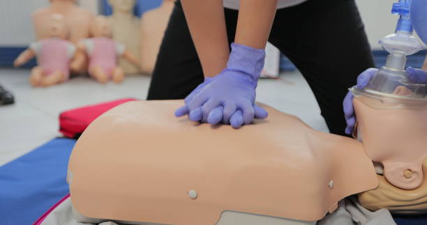 istock CPR training using and an AED and bag mask valve on an adult training manikin. 1349671121