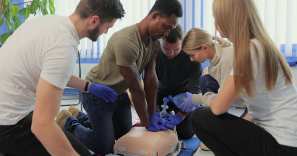 primer plano de los estudiantes que practican la compresión torácica de rcp en el maniquí. - cpr first aid paramedic rescue fotografías e imágenes de stock