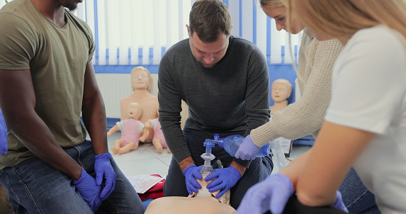 Group of multiethnic people learning how to perform Cpr