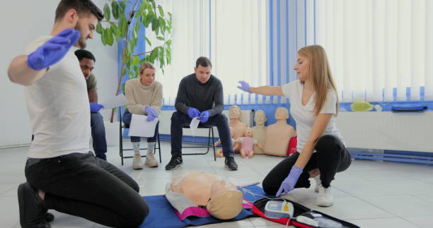 istock Stay away moment during the defibrillation process on a first aid group training indoors. 1349671197