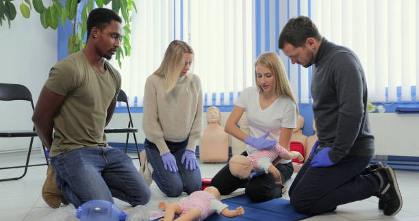 istock People learning how to safe a life when the baby is choked sitting together with instructor during the first aid training indoors. 1349671274