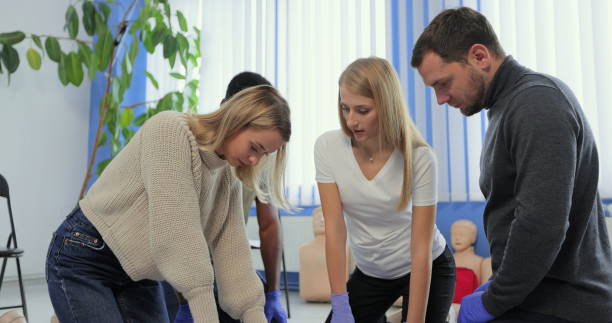 istock Group of people CPR First Aid Baby Training course. Baby CPR dummy first aid training. 1349671521
