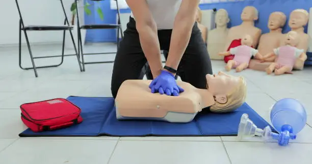 Photo of CPR training and First Aid Instruction. First Aid cardiopulmonary resuscitation.
