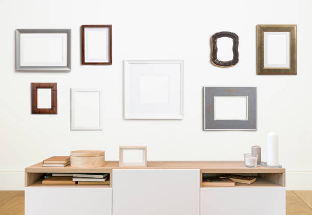 istock Mock up poster frame in interior white wall. White frame for poster or photo image on clean wall in home room or office interior 1349675010