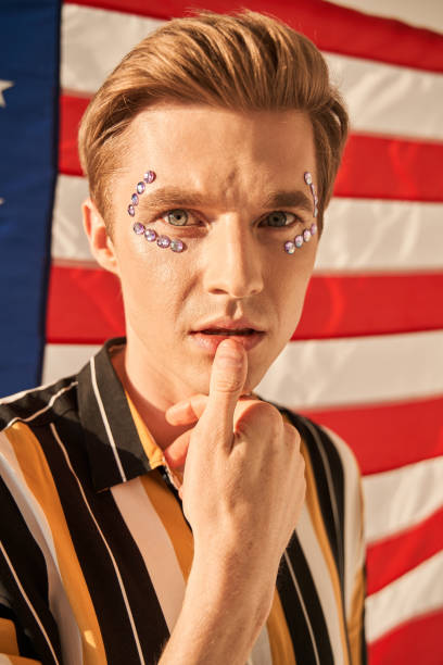 istock Ginger man with rhinestones makeup posing sensual at camera 1349675300